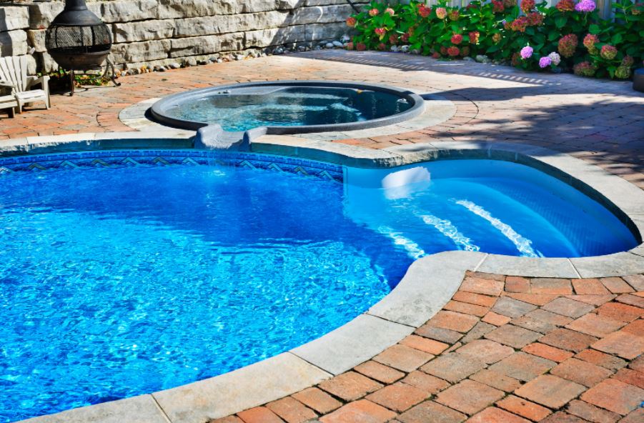 swimming pool with hot tub attached
